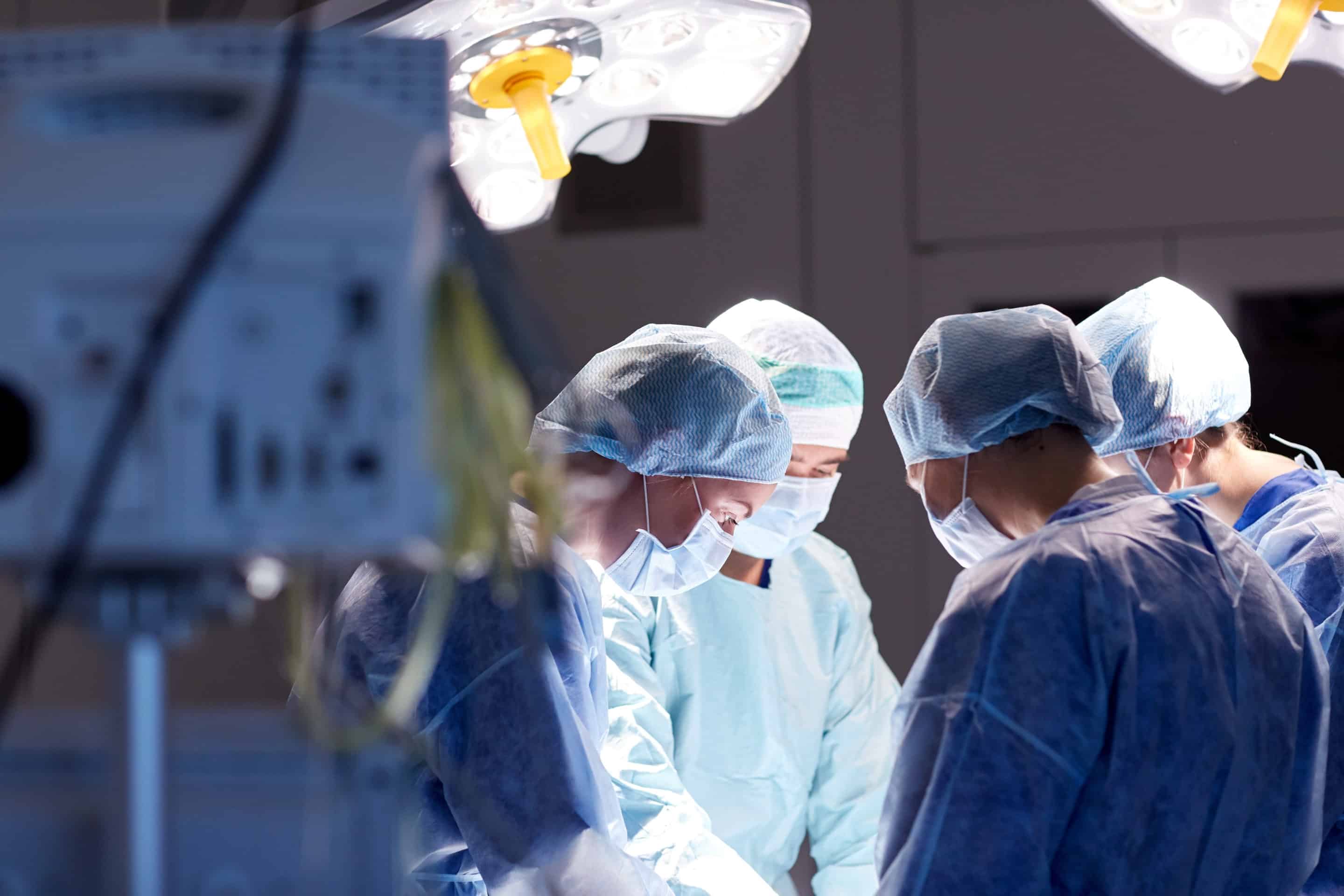 group of surgeons in operating room at hospital